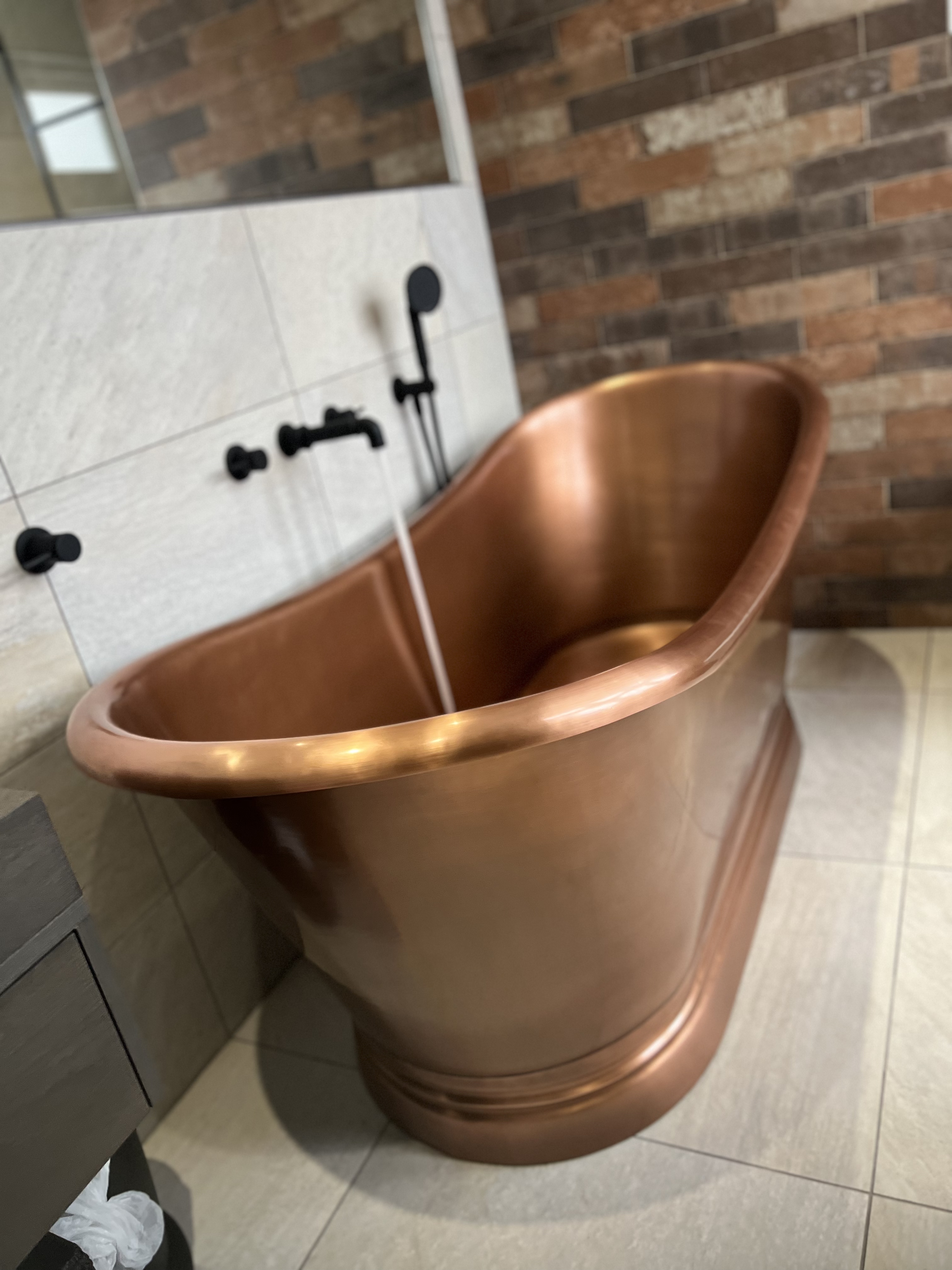 bespoke copper bath with water running